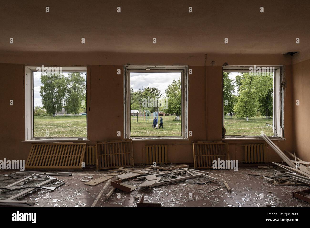 Merefa, Ukraine. 19th May, 2022. People walk by the outside of the Secondary School of Merefa, damaged after Russians shelled it in March 17, in Merefa, Ukraine, south of Kharkiv, Wednesday, May 18, 2022. Finland and Sweden formally submitted applications to join the NATO military alliance early Wednesday, ending the Nordic nations' decades of military neutrality in the wake of Russia's war in Ukraine. Photo by Ken Cedeno/UPI Credit: UPI/Alamy Live News Stock Photo