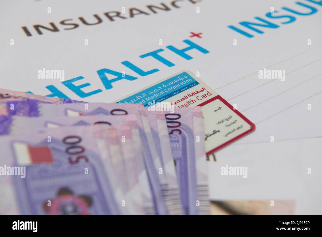 Health insurance form with Qatari Bank Note 500. top view Stock Photo ...