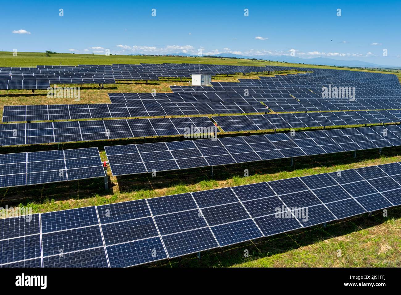 Aerial view photovoltaic panels park on green field in north Greece