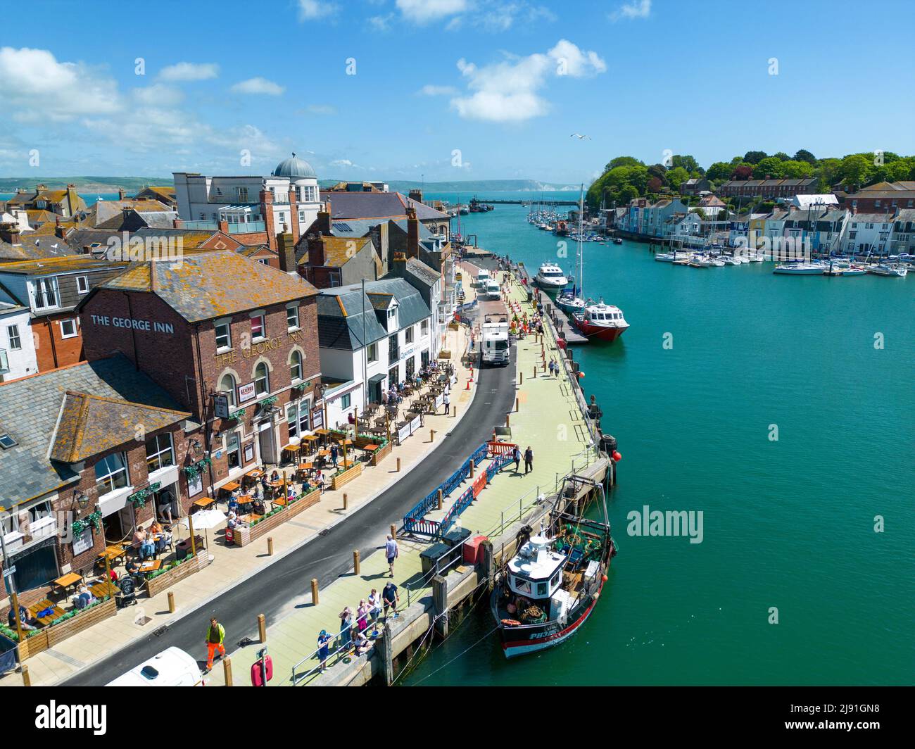 Weymouth, Dorset, UK. 19th May, 2022. An aerial view of the new footpath through Weymouth historic harbour which has been slated as 'disgusting' after it was painted ' Shrek ' green. Dorset Council has now apologised for any confusion and says the quayside work isn't finished and the final colour of the footpath will be 'in keeping with the surroundingsÕ. Picture Credit: Dorset Media Service/Alamy Live News Stock Photo