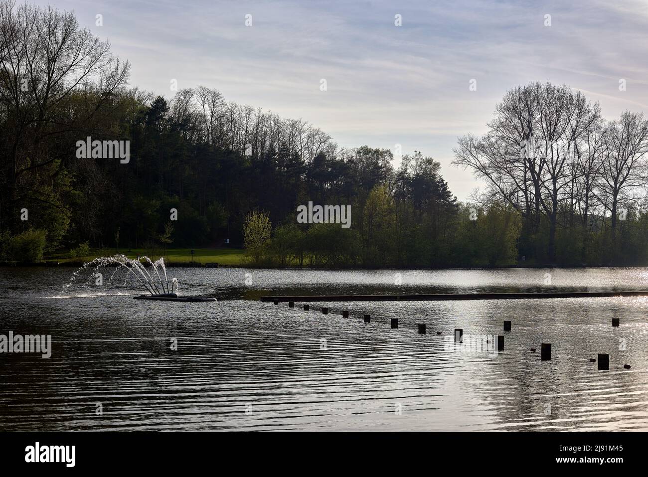 Wooden poles and a fountain on a lake in Ghent - Belgium Stock Photo - Alamy