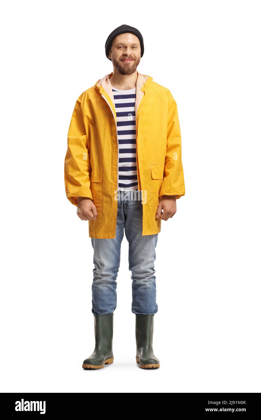 Full length portrait of a man in a yellow raincoat and rubber boots  isolated on white background Stock Photo - Alamy