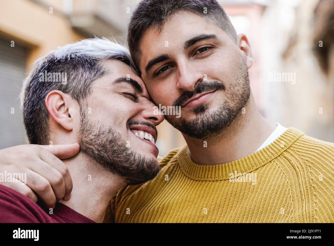 Gay male couple kissing outdoor in the city - LGBT love concept Stock Photo