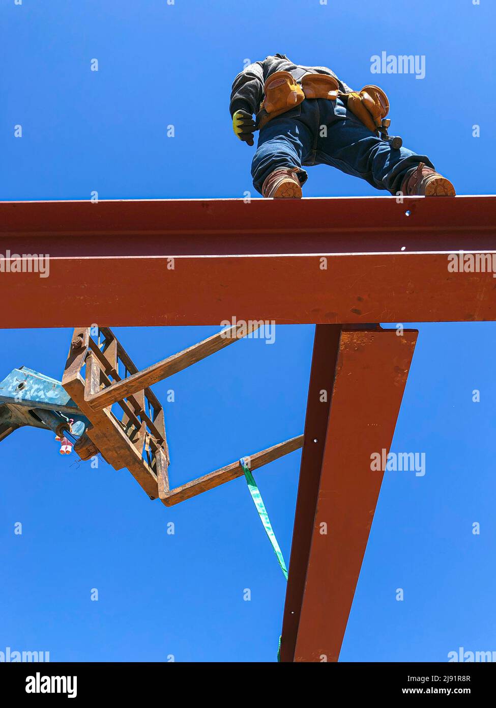 framing construction, worker placing metal beam Stock Photo Alamy