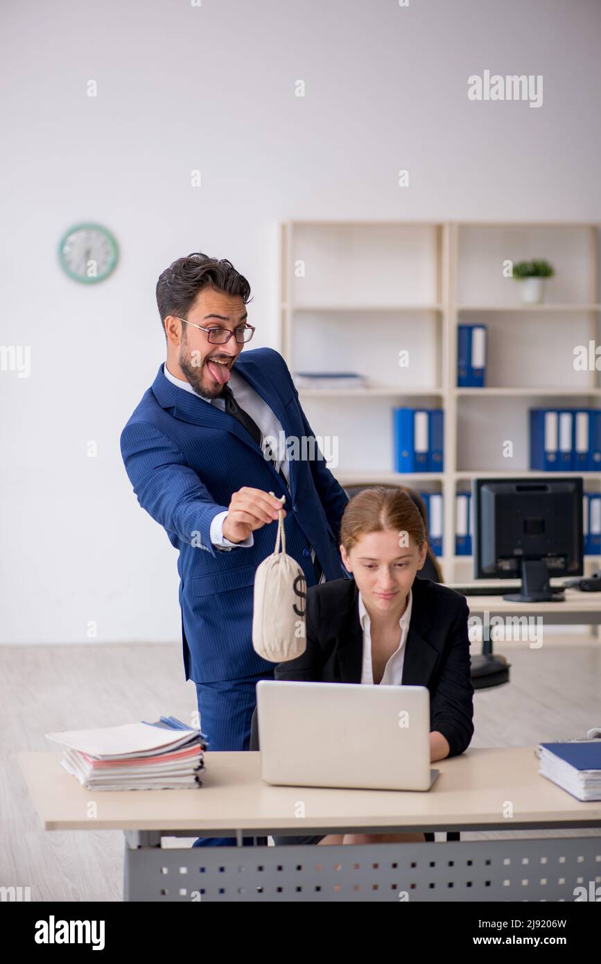 Boss and young secretary in remuneration concept Stock Photo - Alamy