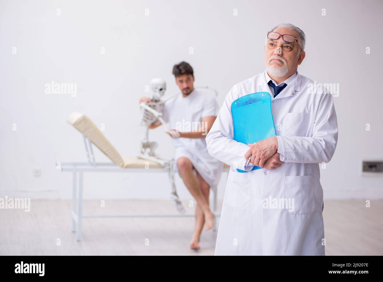 Old doctor psychiatrist examining young male patient Stock Photo Alamy