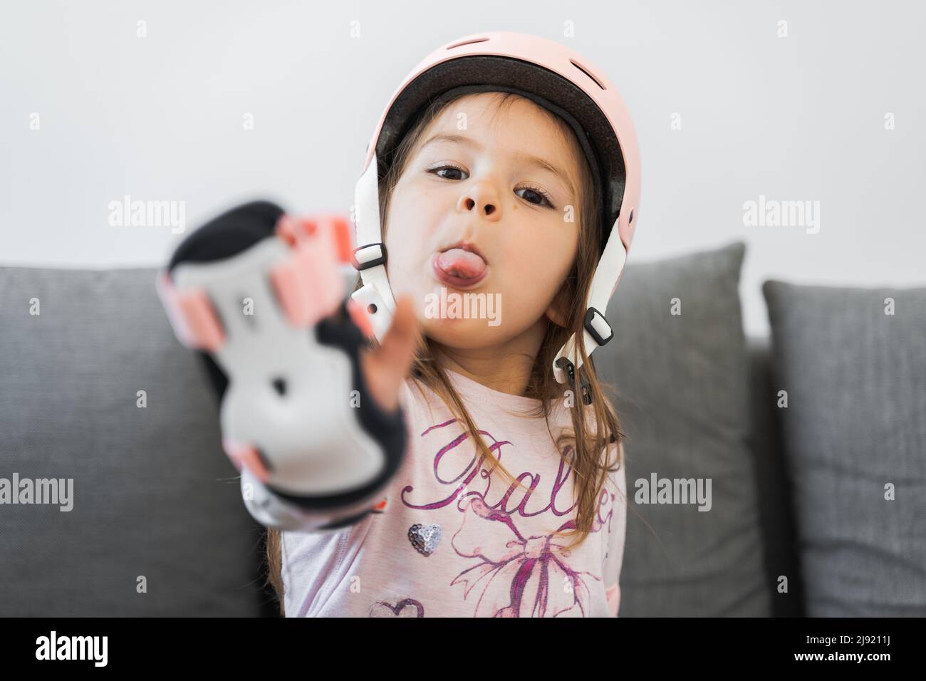 Preschool girl portrait with safety for outdoors activities. Pink