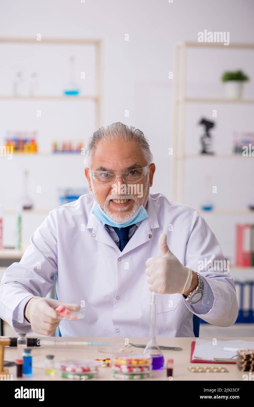 Old chemist in drug synthesis concept Stock Photo Alamy