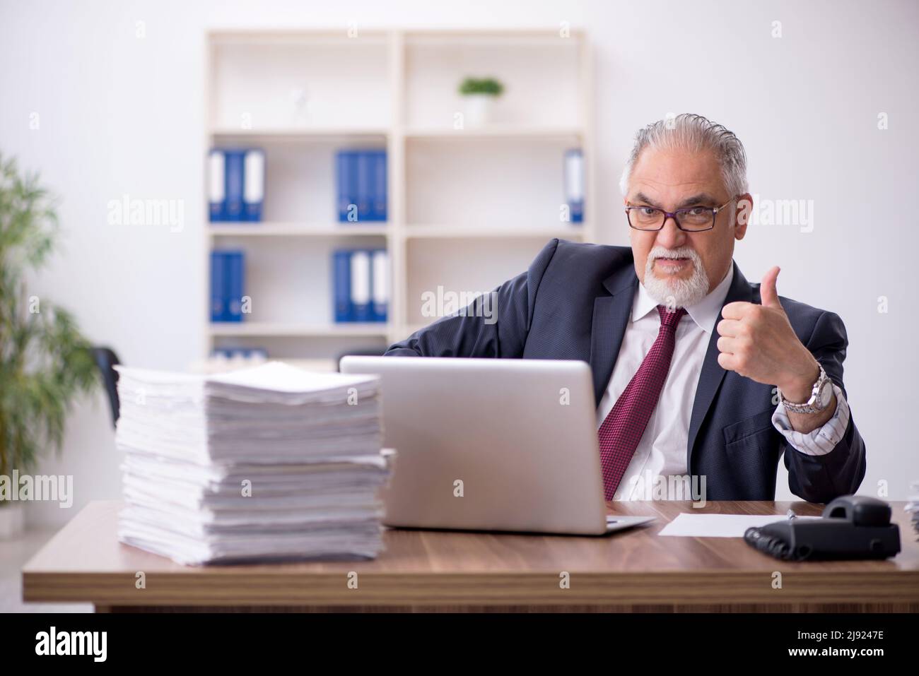 Old employee and too much work in the office Stock Photo Alamy