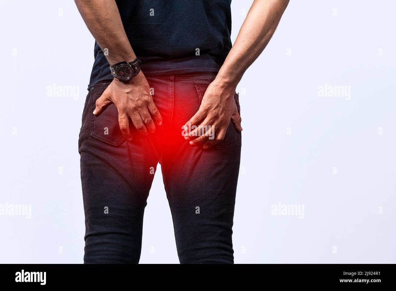 People with digestive problem touching his buttock, man with hemorrhoid problem on isolated background, People with diarrhea problem Stock Photo