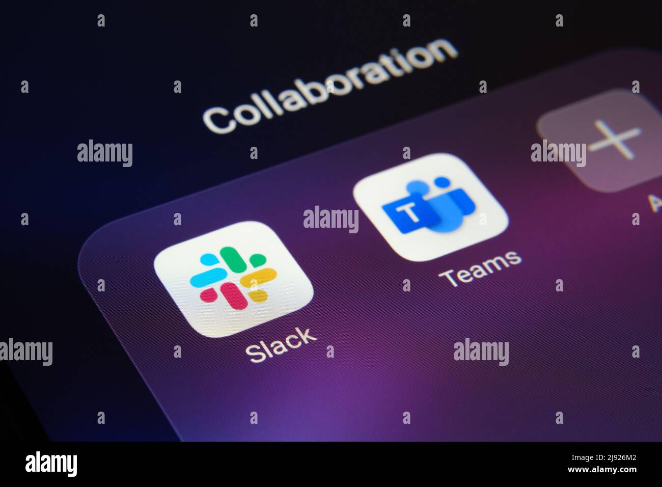 Corner of smartphone with Slack and Teams apps. Concept for competition. Stafford, United Kingdom, May 19, 2022. Stock Photo