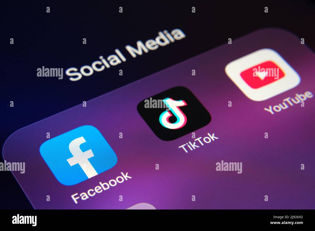 Corner of smartphone with Facebook, TikTok, Youtube apps. Concept for competition. Stafford, United Kingdom, May 19, 2022. Stock Photo