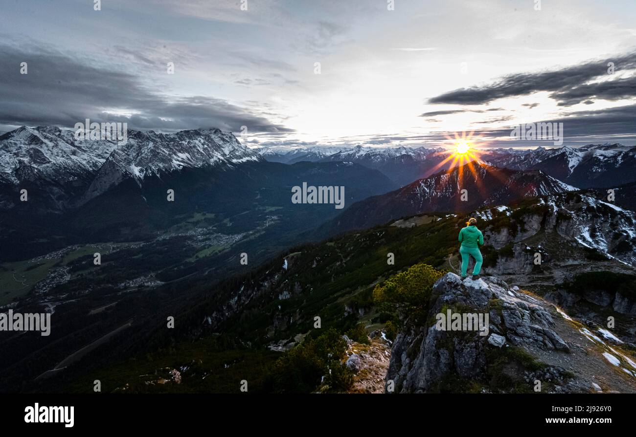 Sunset, Young Hiker at the Kramerspitz, Wetterstein Mountains and Zugspitze in the background, Bavaria, Germany Stock Photo