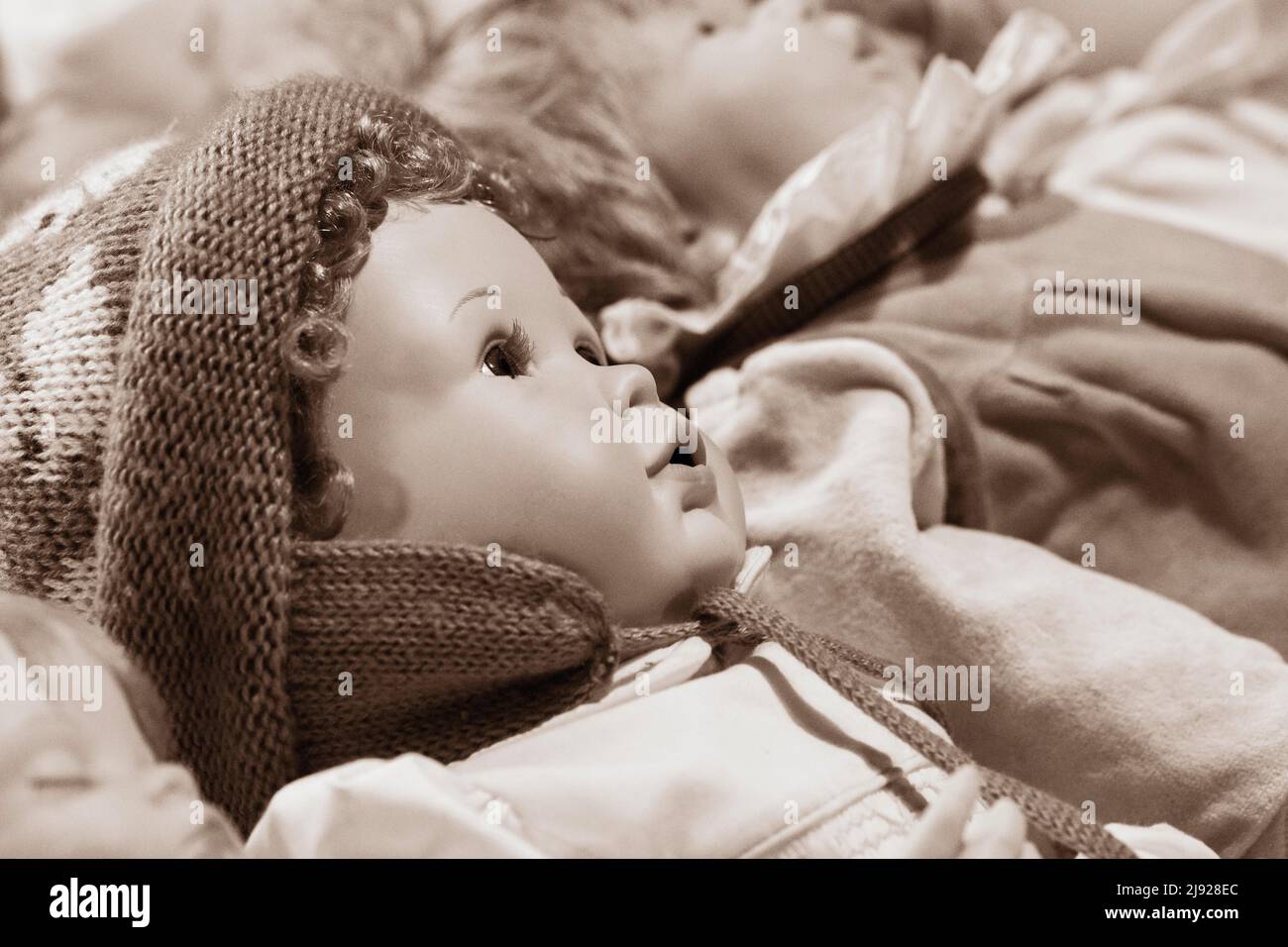 Sepia colours, portrait of an old decorative baby doll, children's toy, symbolic image, Austria Stock Photo