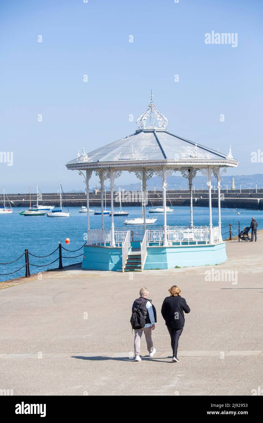 Promenade with passersby and pavilion at Dun Laoghaire on a nice day
