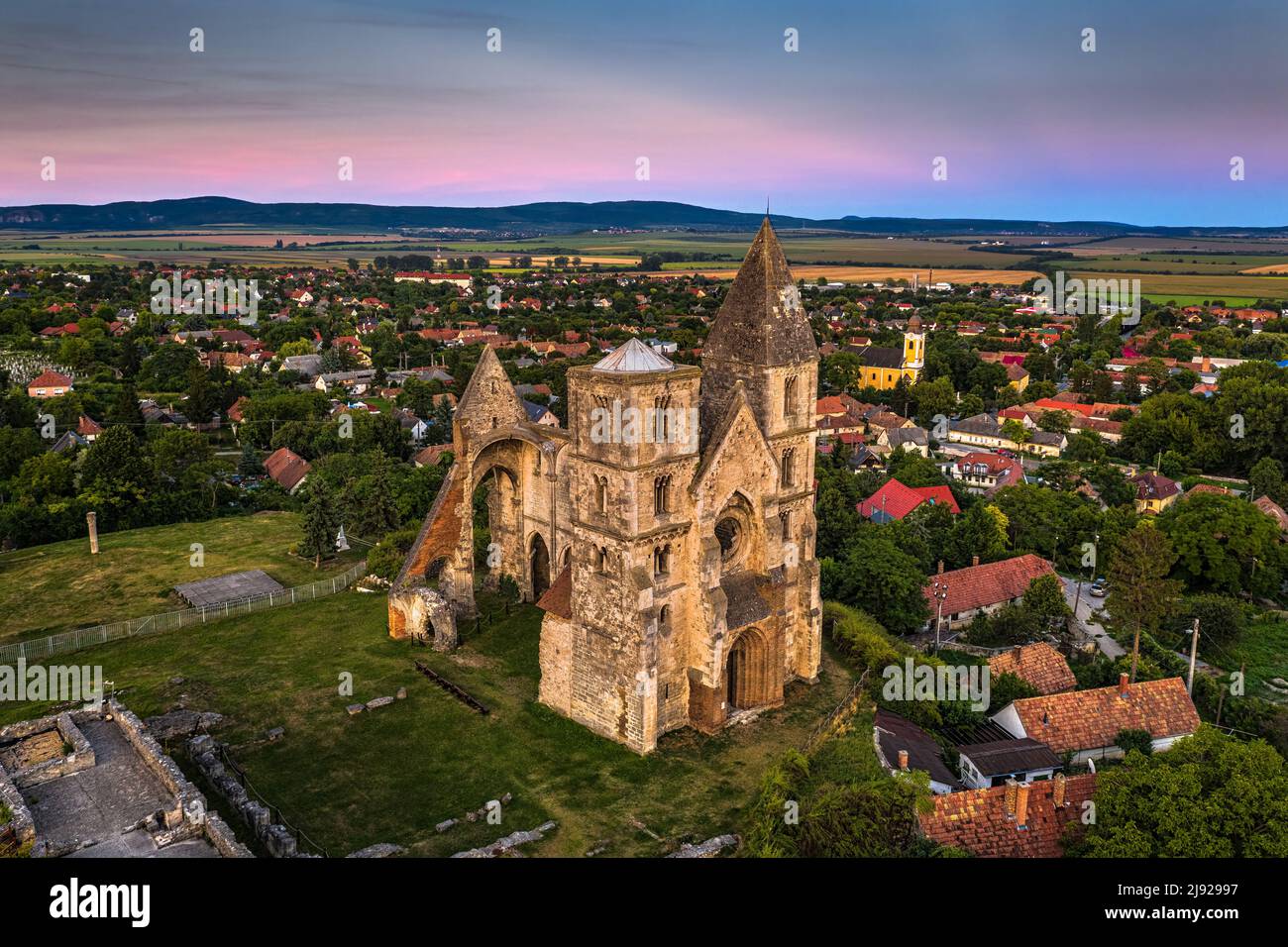 Zsambek, Hungary - Aerial view of the beautiful Premontre Monastery ruin church of Zsambek (Schambeck) with cemetery and ccolorful sky at background a Stock Photo