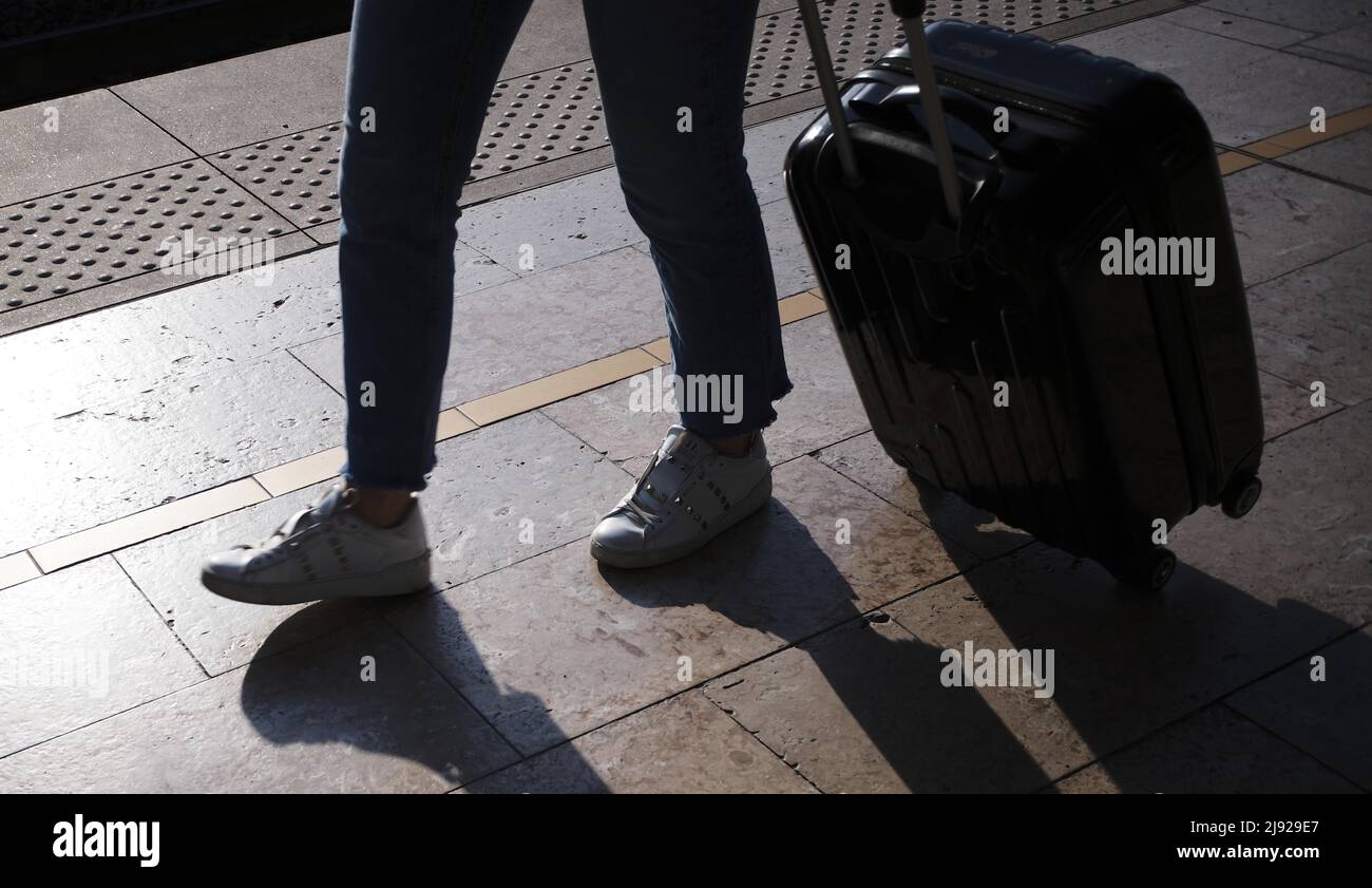 Passengers on the platform, silhouette, shadow, hand luggage, suitcase