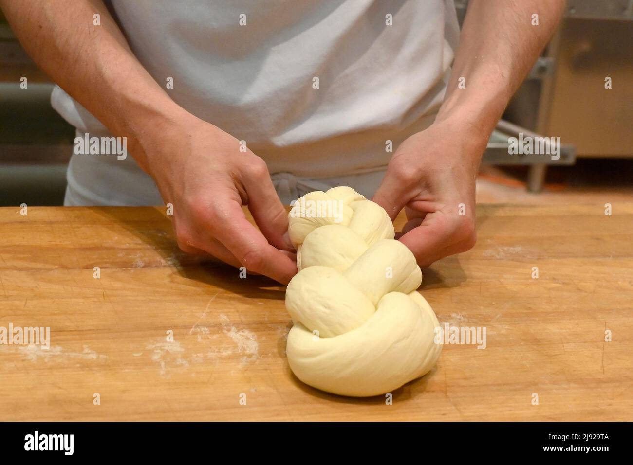 Bakers plaiting butter plait Stock Photo
