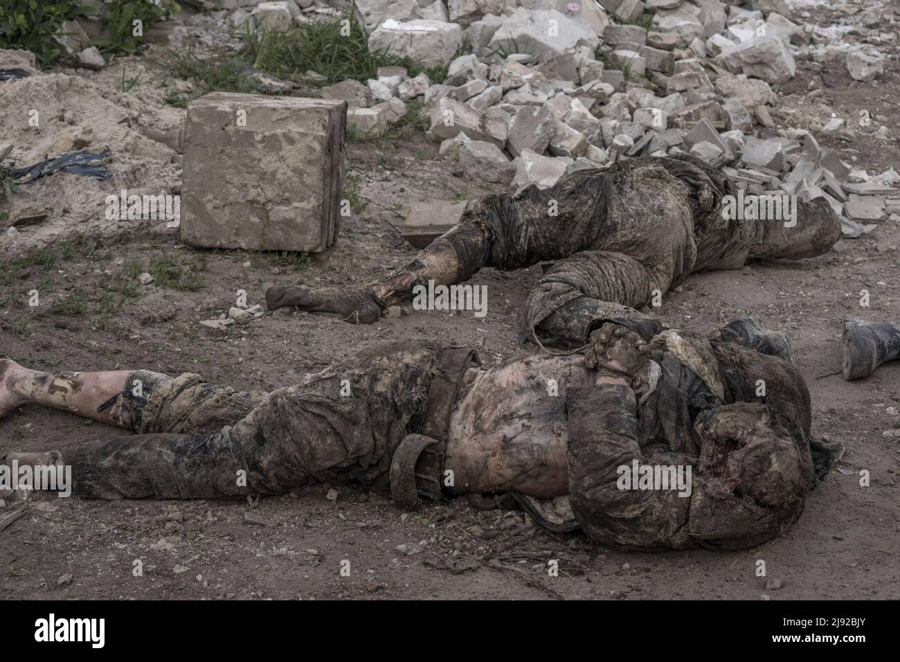 Malaya Rohan, Ukraine. 19th May, 2022. Men pull the bodies of two dead Russian soldiers out from where they were buried in a persons front yard in Mala Rohan, Ukraine, Thursday, May 19, 2022. Mala Rohan is a small village retaken by the Ukrainian forces, after Russia's attack on Ukraine. EDITORS NOTE CONTENT. Photo by Ken Cedeno/UPI Credit: UPI/Alamy Live News Stock Photo