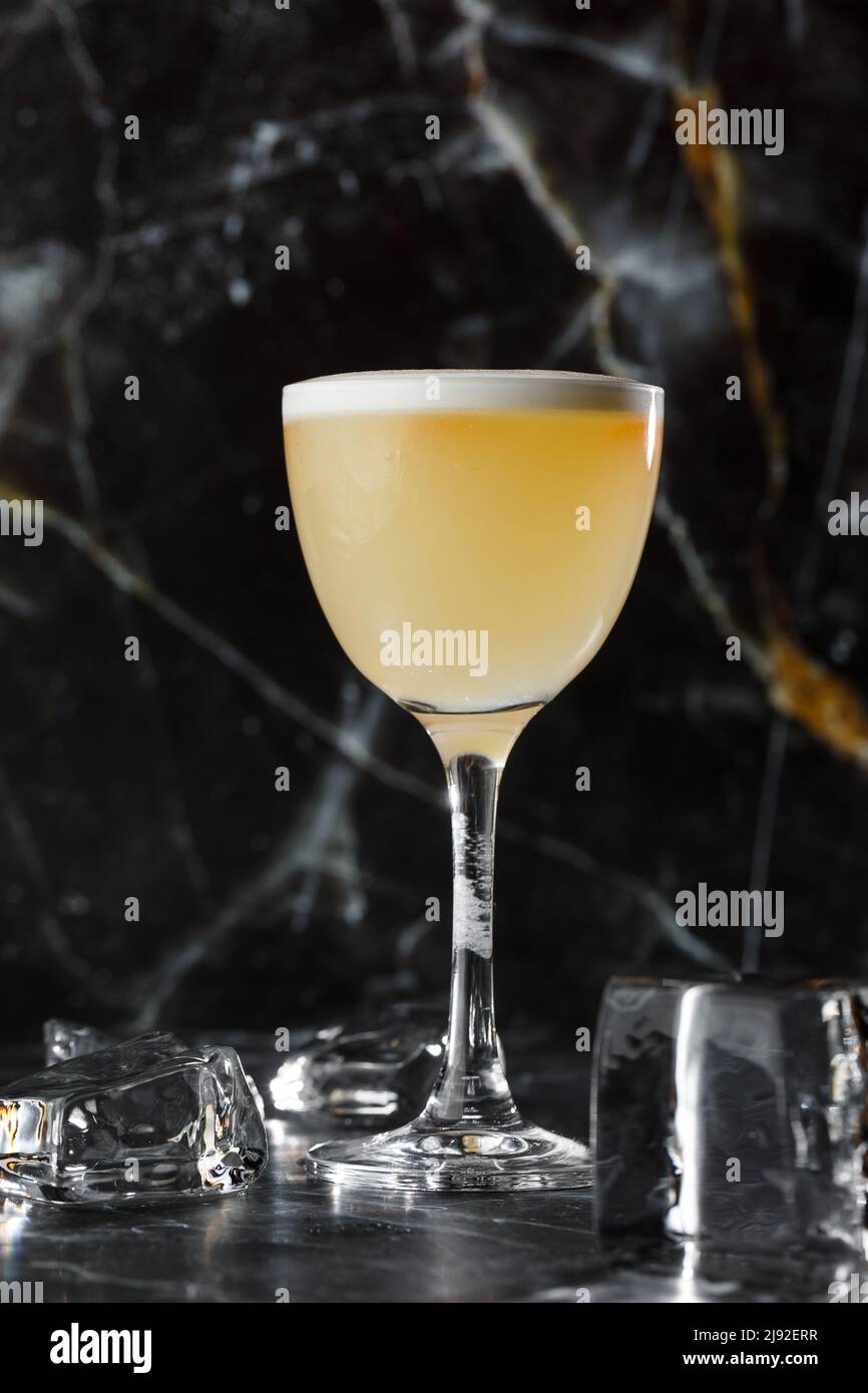 Pisco sour cocktail whiskey with lime, egg white, sugar syrup in