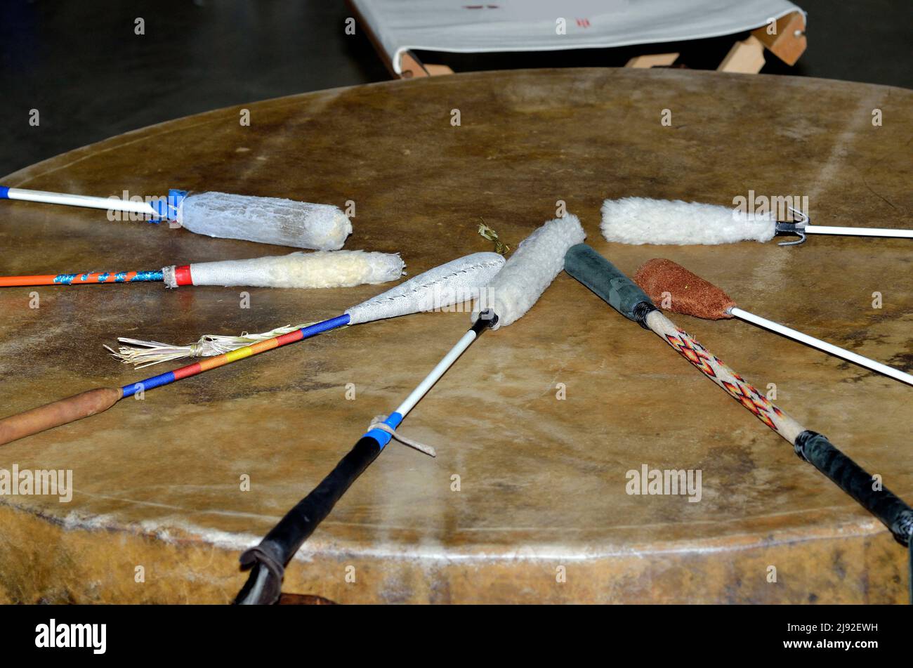 A large American Indian powwow drum with 7 decorative mallets on top. Stock Photo