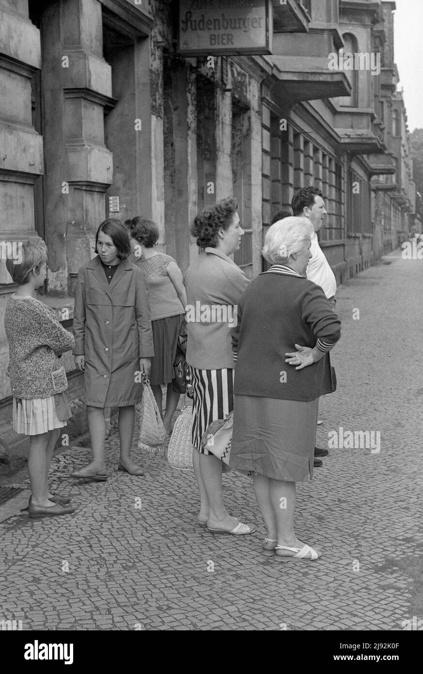 01.06.1967, Magdeburg, Magdeburg district, German Democratic Republic - People standing on a sidewalk. 00S670601D327CAROEX.JPG [MODEL RELEASE: NO, PRO Stock Photo
