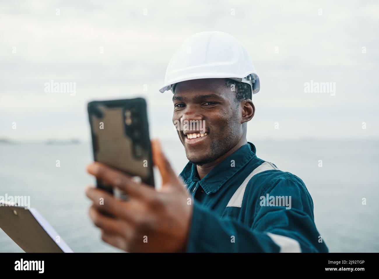 Optimistic African American worker making video call near sea Stock Photo