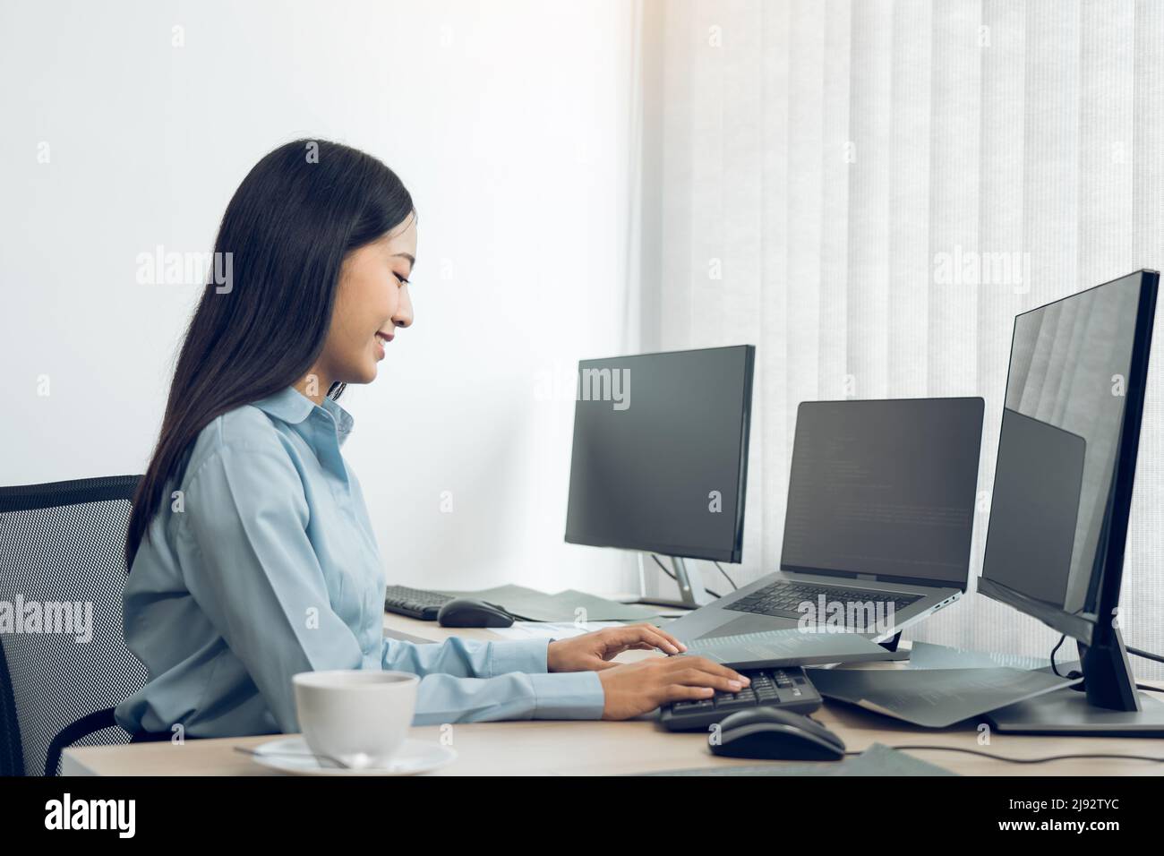 Asian young female programmer working developer programing on a computer code at office. Stock Photo