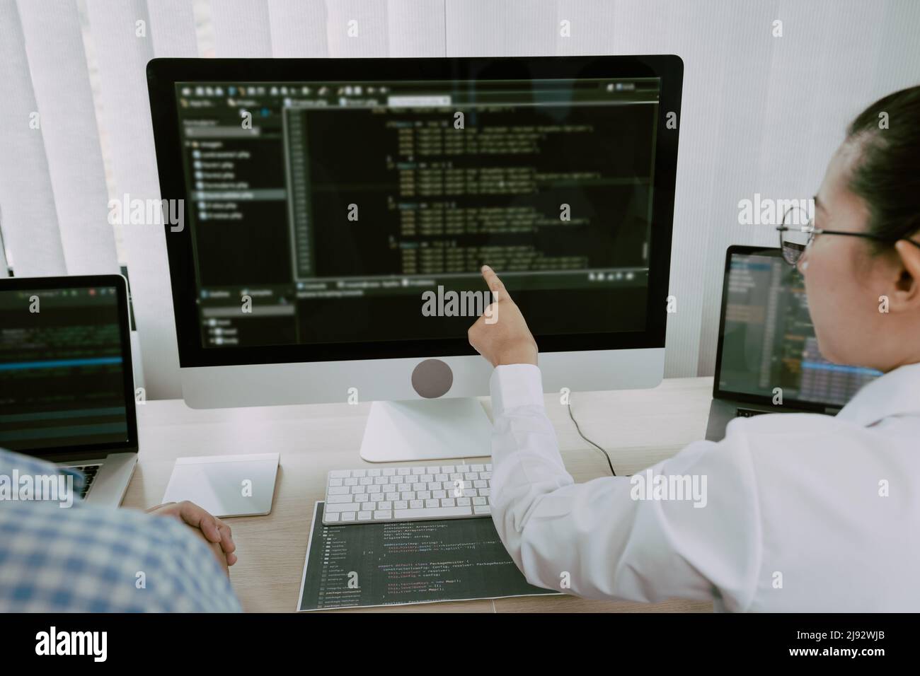 Two asian team working development of programming and encryption technology website design programmers on desk in office. Stock Photo