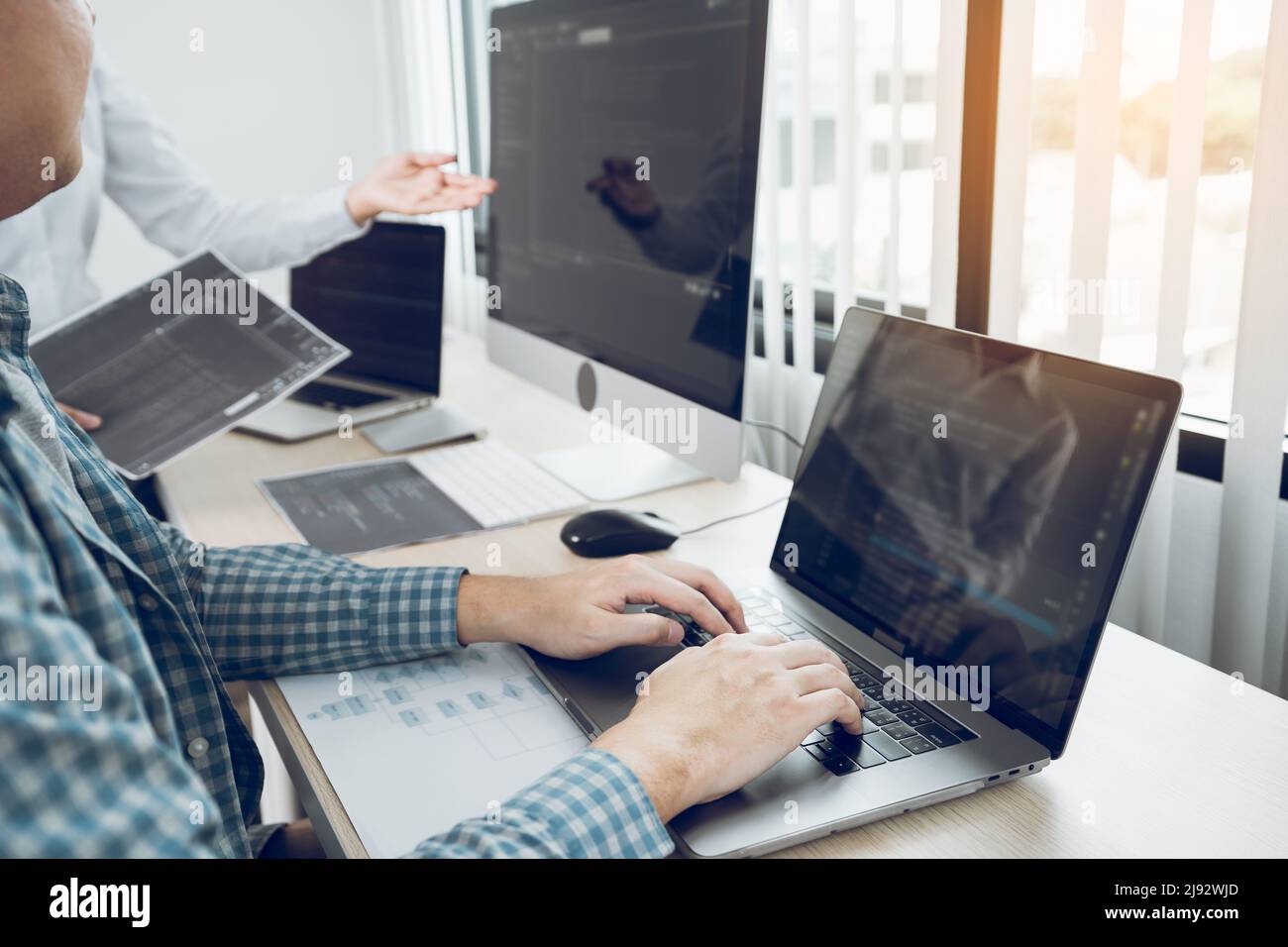 Two asian team working development of programming and encryption technology website design programmers on desk in office. Stock Photo