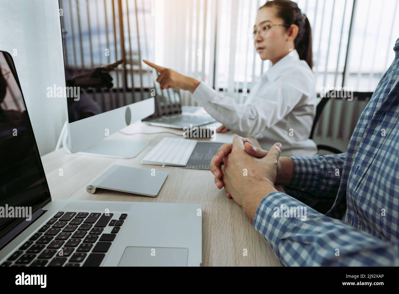 Two partnerships developing programming and coding technologies working on laptop and analyzing together. Stock Photo