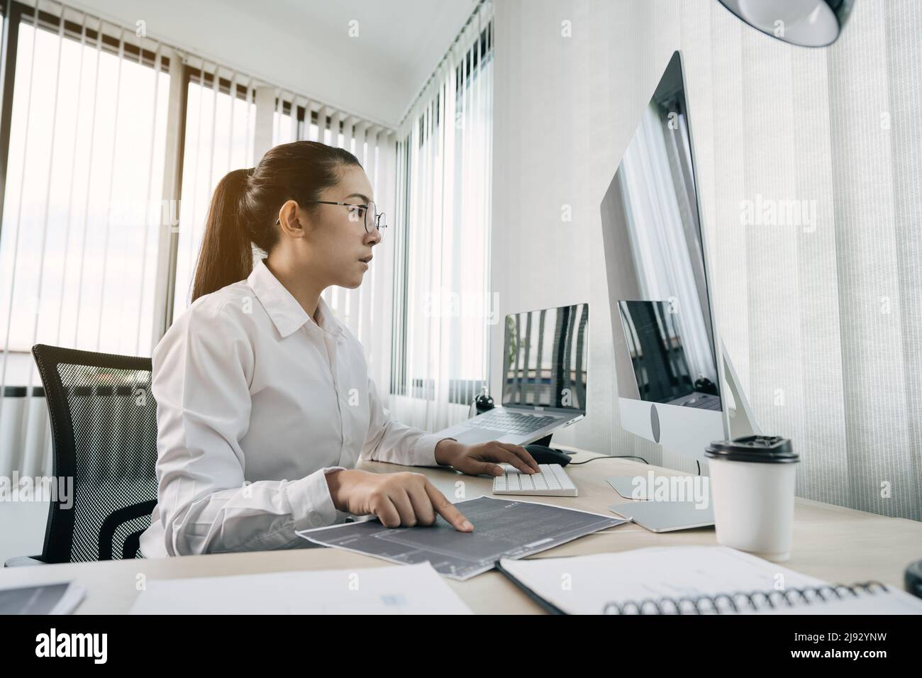 Developing programming and coding technology working in a software engineers developing applications in office. Stock Photo