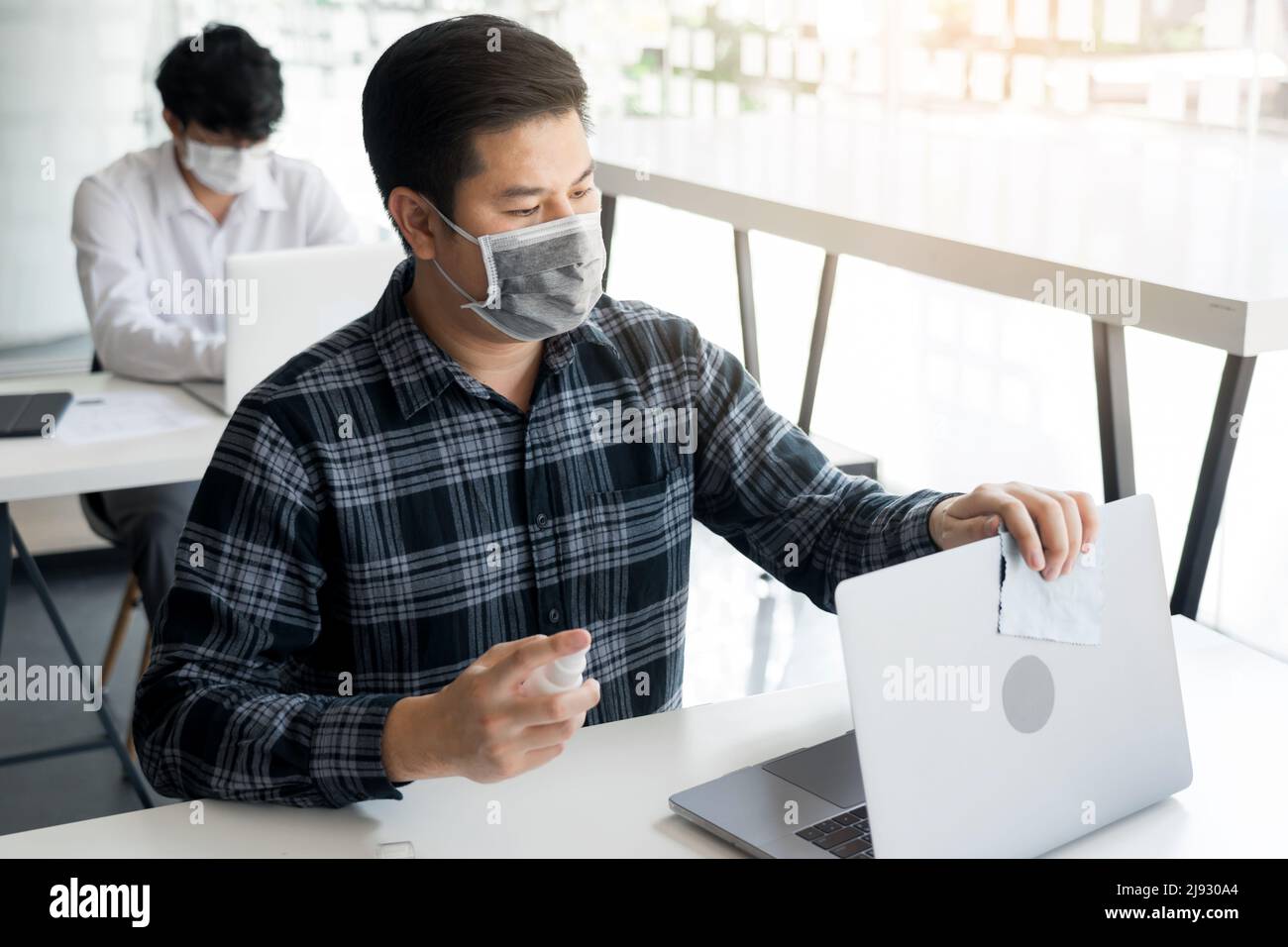 Employees are spraying with alcohol to wipe clean office equipment ...