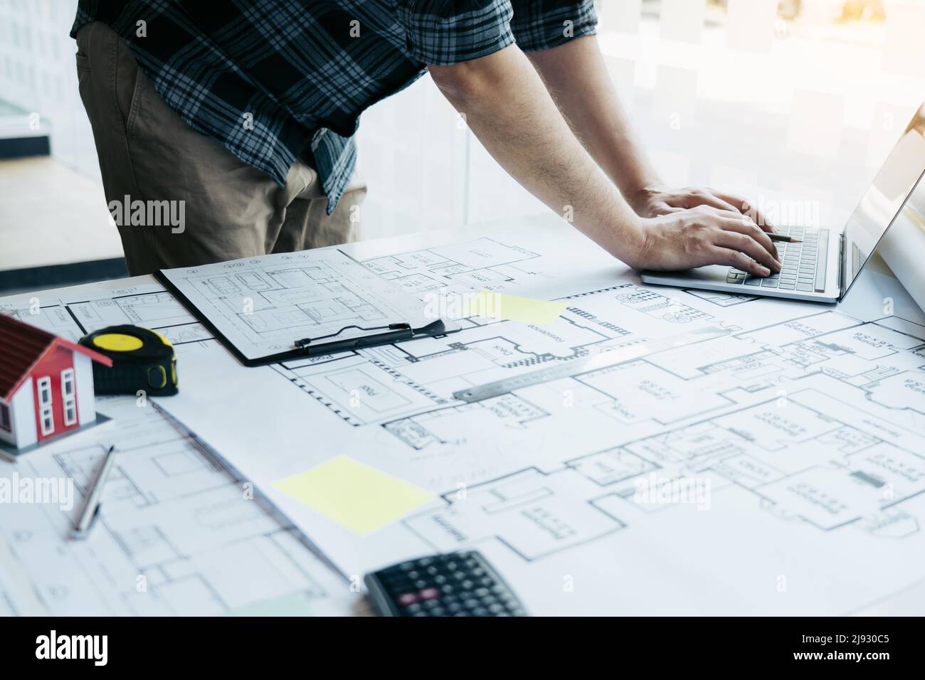 Architect working new project and using laptop with in office. Stock Photo
