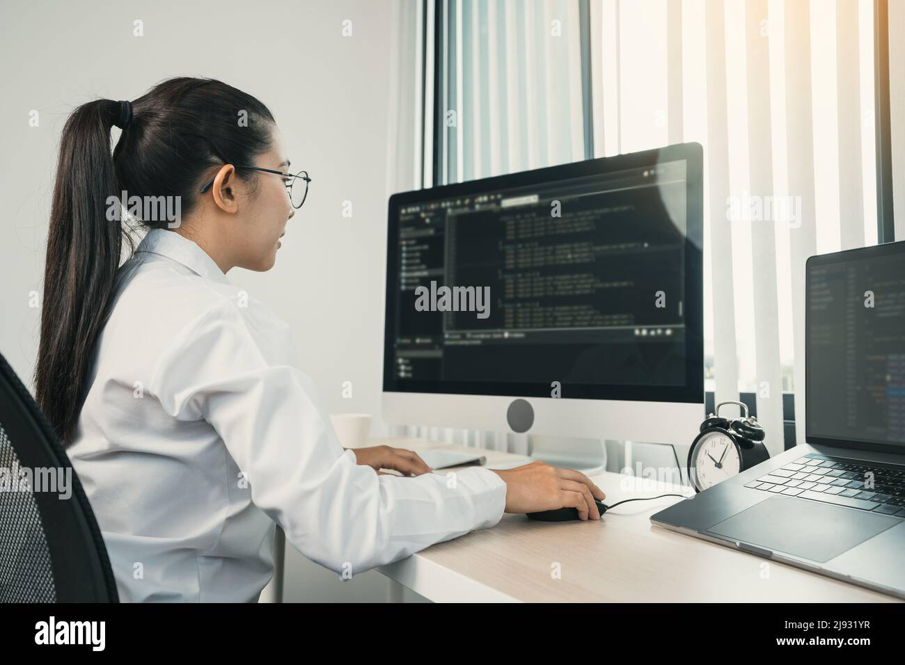 Developing programming and coding technology working in a software engineers developing applications in office. Stock Photo