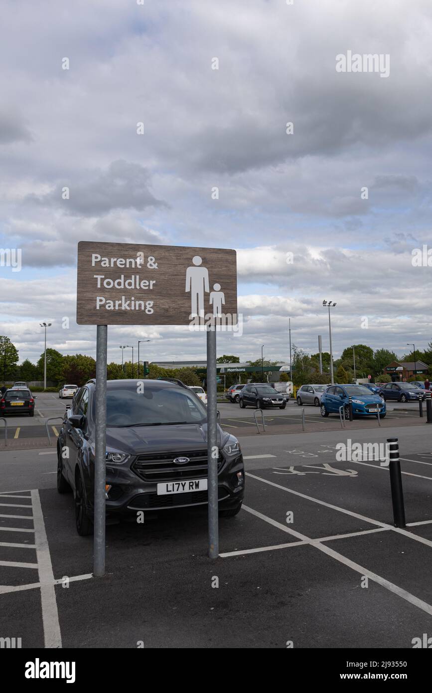 Parent and toddler parking sign at Morrisons supermarket Starbeck store car park Stock Photo