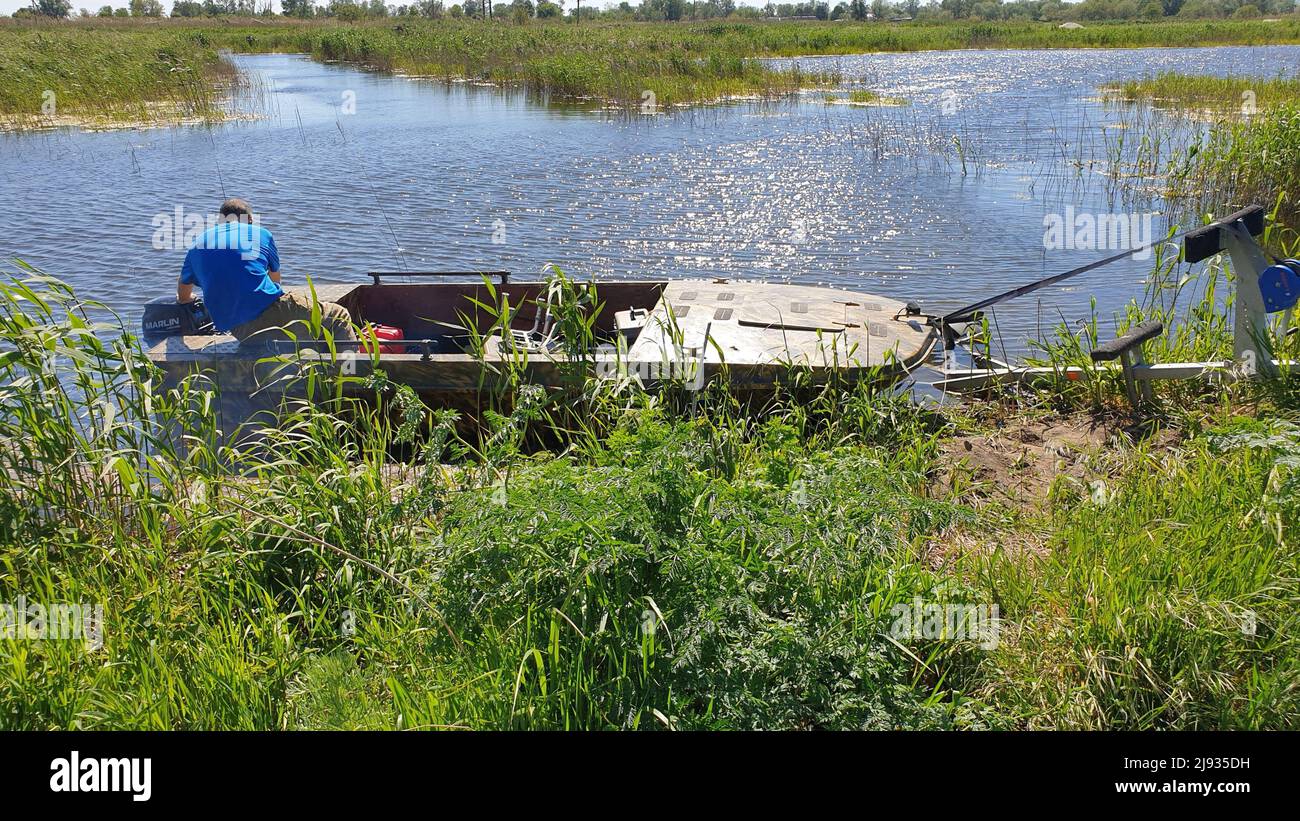 A man launches a motorboat Stock Photo - Alamy