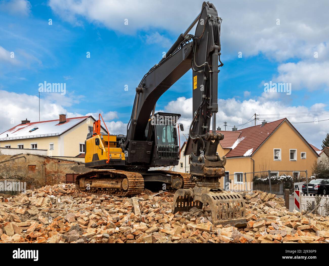 Excavator on debris of a demolished building in Germany Stock Photo