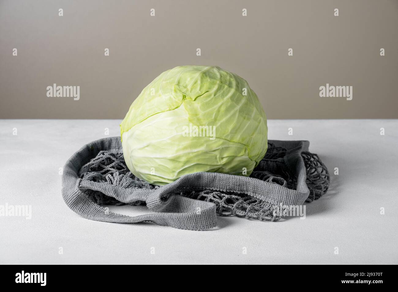 White cabbage lie on the surface in environmentally friendly bag Stock Photo