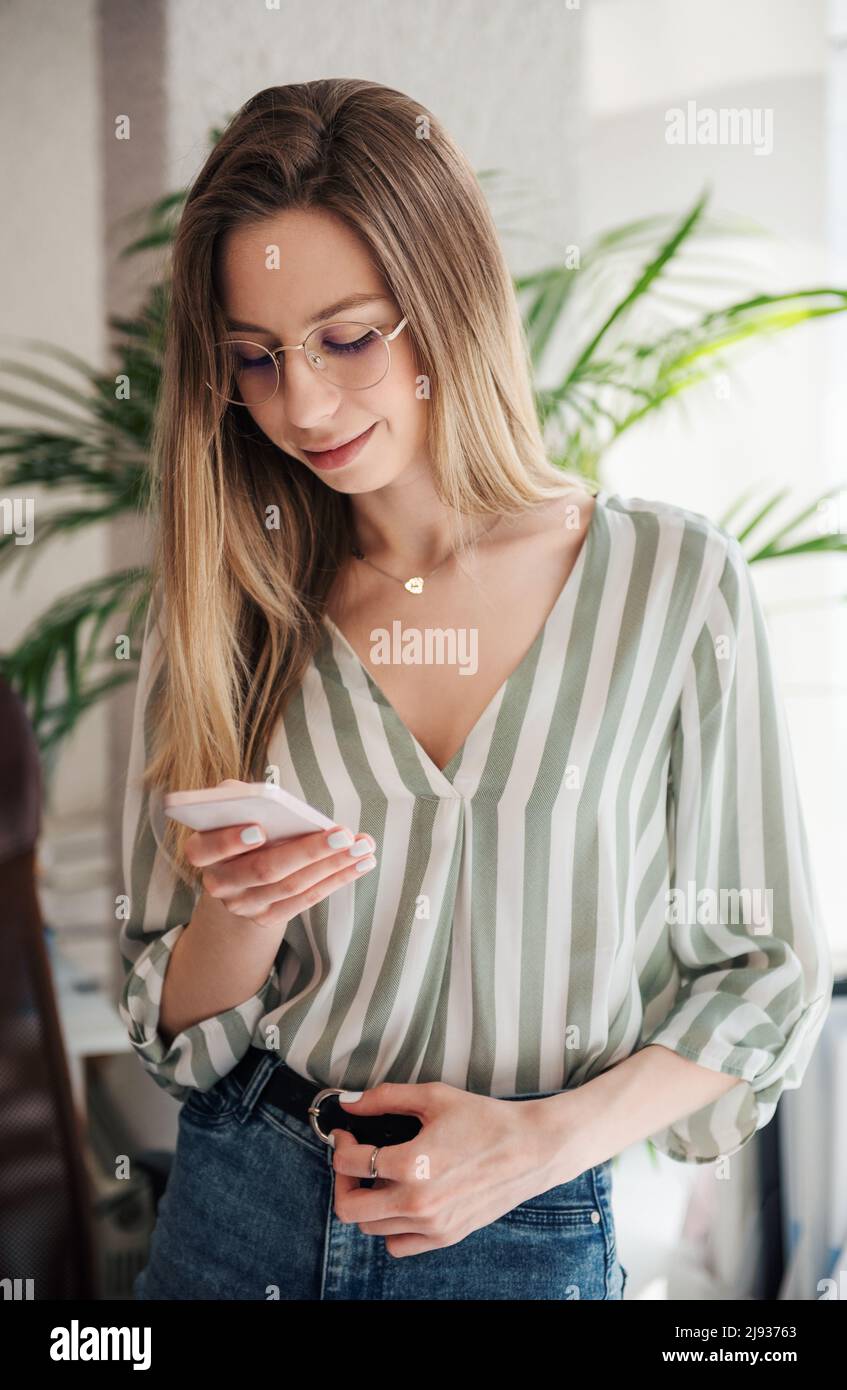 Young woman working on a computer in her office Stock Photo - Alamy