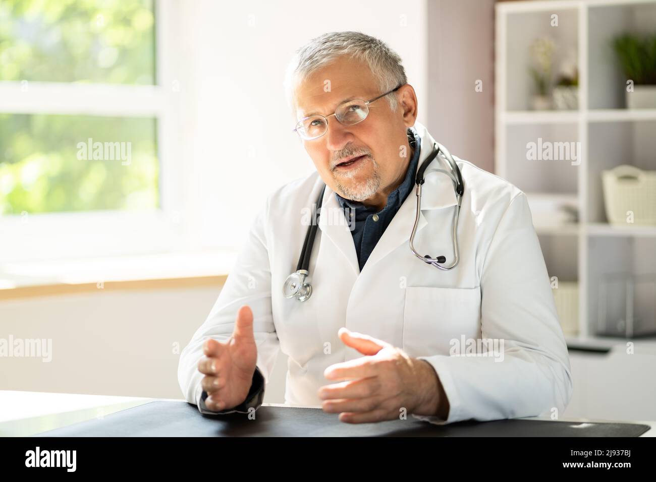 Portrait happy mature doctor hi-res stock photography and images - Alamy