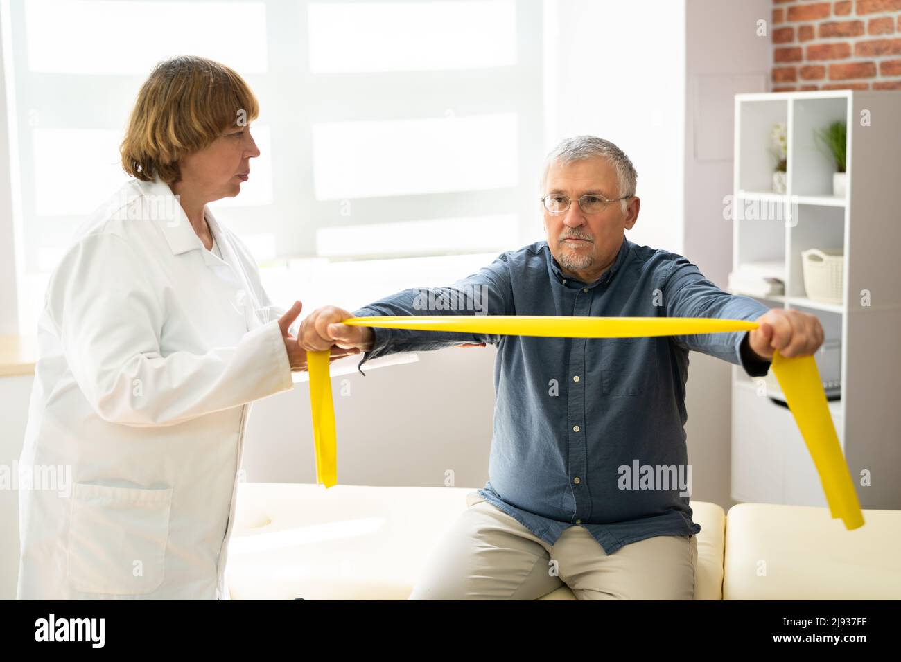 Physical Therapy Patient Using Physiotherapy Bands For Rehabilitation Stock Photo Alamy