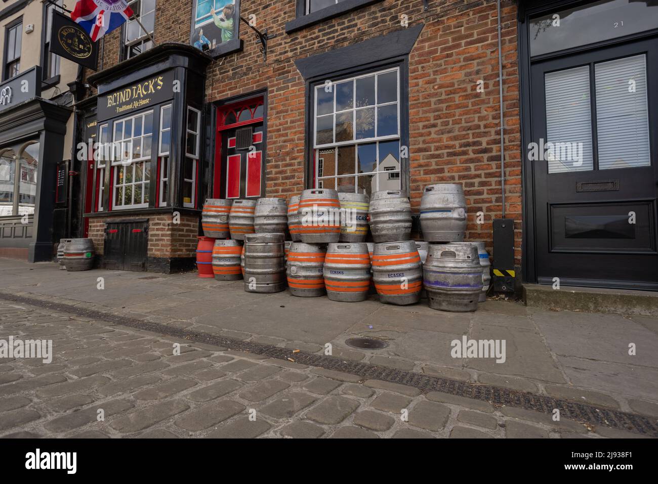 Low angle view of kegs with colourful locators outside Blind Jack's Traditional Ale House in Knaresborough North Yorkshire named after Jack Metcalf t Stock Photo