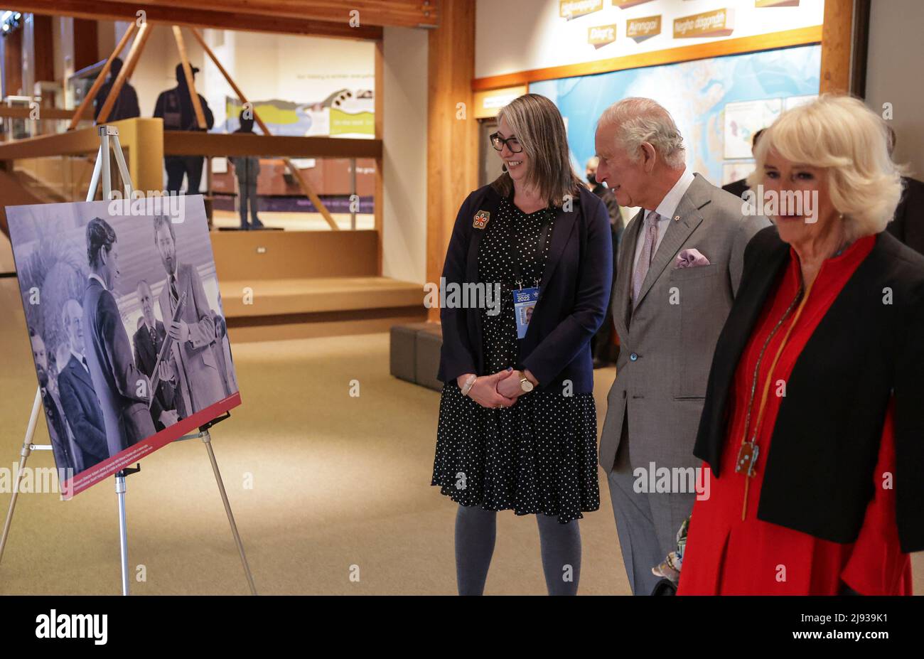 The Prince of Wales and Duchess of Cornwall with Dr Sarah Carr-Locke, Director of The Prince of Wales Northern Heritage Centre Wales, viewing a display of archival images from the opening in 1979 and learn about how the Heritage Centre has evolved throughout the decades since Charles' last visit, as they visit the Heritage Centre in Yellowknife during their three-day trip to Canada to mark the Queen's Platinum Jubilee. Picture date: Thursday May 19, 2022. Stock Photo