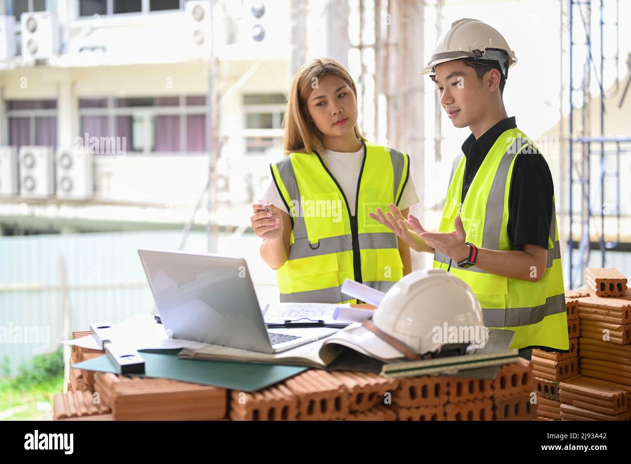 Civil engineer and specialists working, checking plan together at