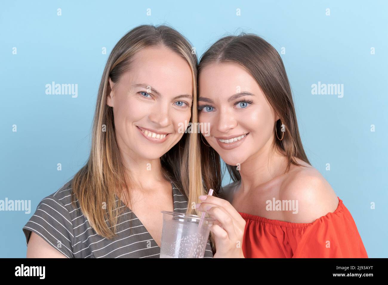 Cute Girl Is Having Fun With Her Stylish Mom In Red Dress Drinking 
