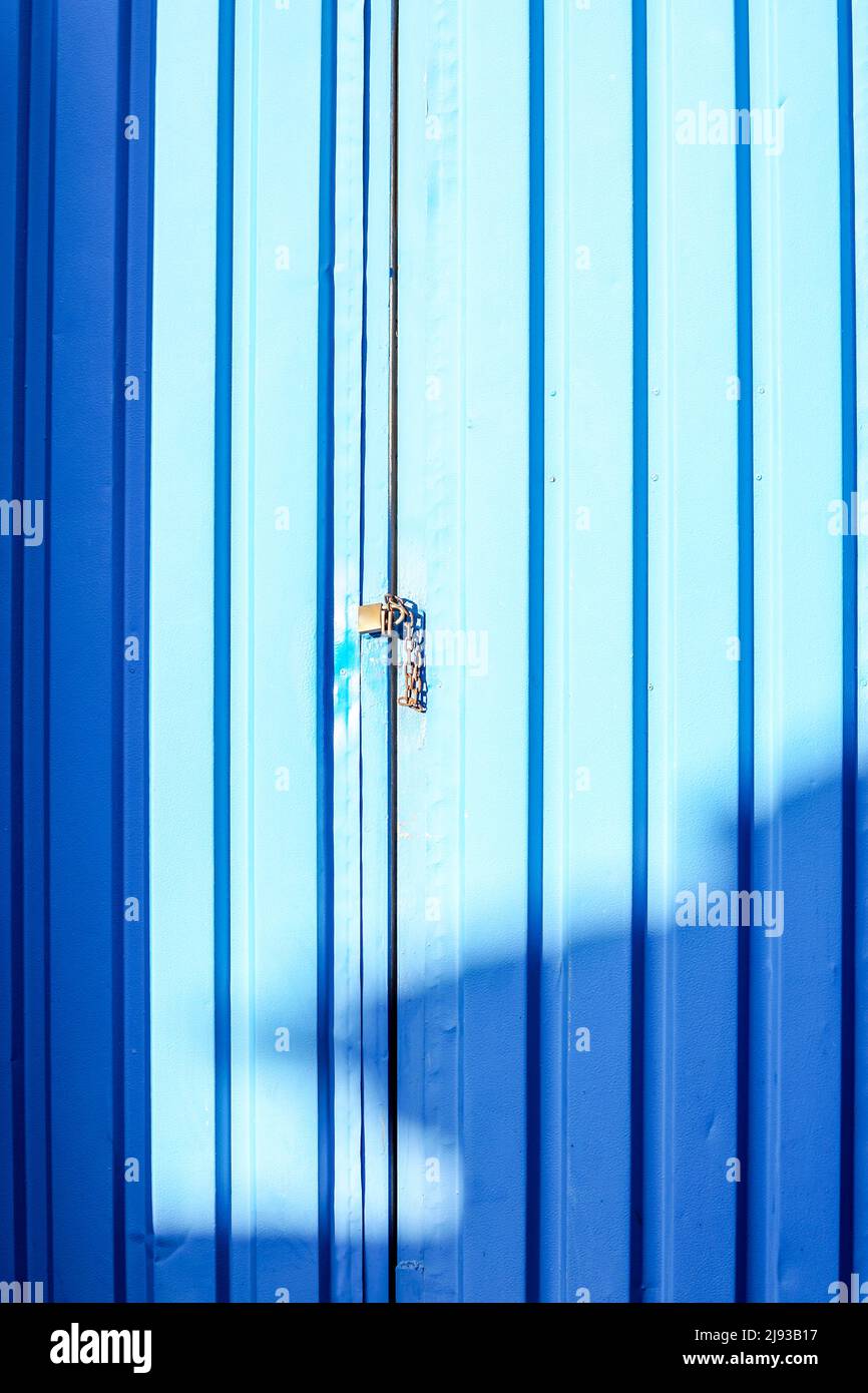 closeup of a metal padlocked door concept industrial safety and security, closed for business, out of business Stock Photo