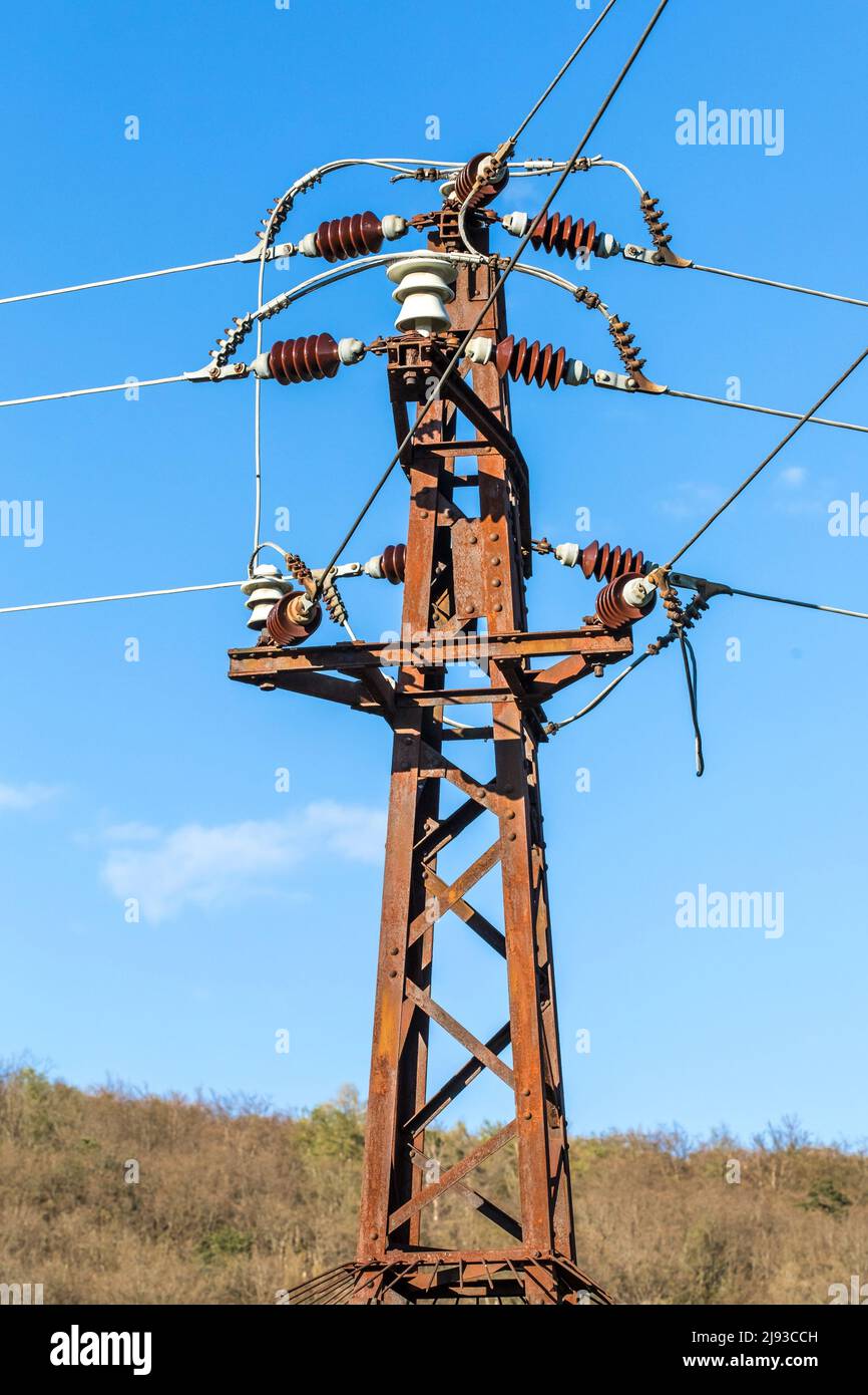 Old rusty electricity supply. High voltage power line. Electricity pole and wires on a sky