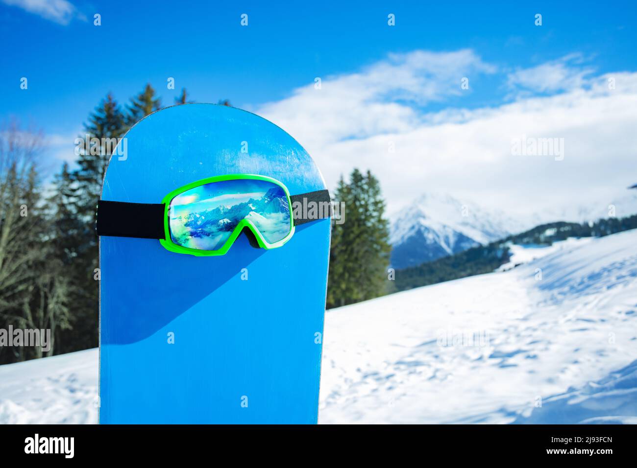 Alpine ski mask on the blue snowboard over mountain range Stock Photo