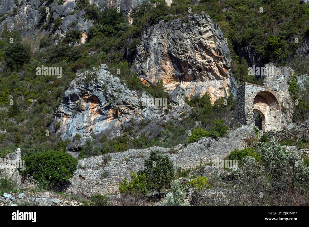 Remains of the medieval stone wall and entrance port to Saint Guillhem le Desert in the Herault department in the south of France. Stock Photo